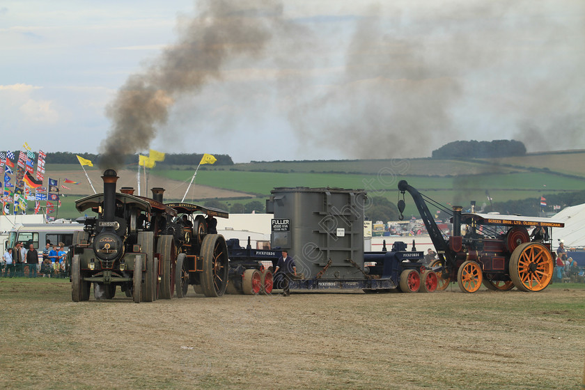 IMG 2455 
 Four Steam Traction Engine's, haul a transformer in the Heavy Haulage Arena at the Great Dorset Steam Fair. 
 Keywords: Four Steam Traction Engines Haul Haulage Transformer Heavy Arena Great Dorset Steam Fair GDSF Chimney Chimneys Smoke Wheel Wheels Flywheel Brass Red Yellow Grey Canopy Low Loader Governor Whistle Pull Pulling Machinery