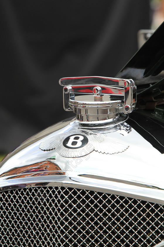 IMG 4963 
 Bentley Vintage car insignia and radiator cap detail. 
 Keywords: Bentley Insignia Logo Badge Radiator Cap Detail Vintage Classic British Transport Shiny Reflection