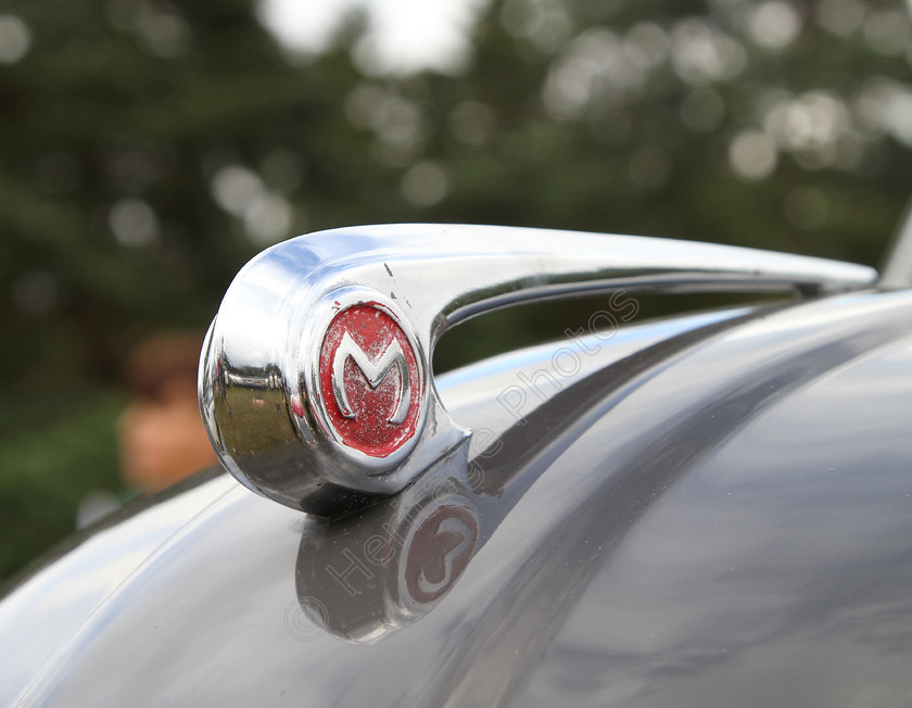 IMG 1361C 
 Morris car mascot. 
 Keywords: Morris Car Mascot Logo Red British Classic Bonnet Chrome Silver Transport Vehicle