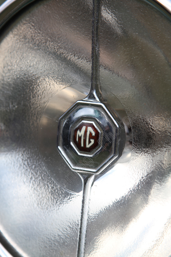 IMG 1396 
 MG car headlight logo detail. 
 Keywords: MG Car Headlight Logo Detail Brown White Silver Reflector Electric Badge Reflection