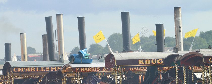 IMG 2304C 
 Chimneys of Showmans Engines at the Great Dorset Steam Fair. 
 Keywords: Chimneys Showmans Engines Great Dorset Steam Fair GDSF Smoke Flag Steam Yellow Canopy Machinery Haulage Haul Power Fairground Rides Electricity