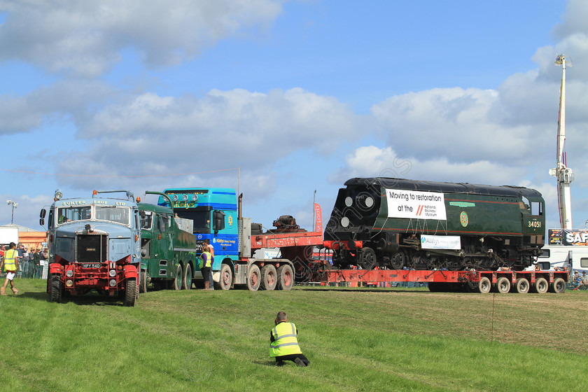 IMG 1409 
 34051 'Winston Churchill' Steam Train, 'Battle Of Britain' class on low loader at the Great Dorset Steam Fair, being helped along by two Scammell diesel tractor units. 
 Keywords: 34051 Winston Churchill Steam Train Tracks Demonstration Low Loader Great Dorset Steam Fair GDSF Heavy Haulage Transport Pull Pulling Blue Green Track