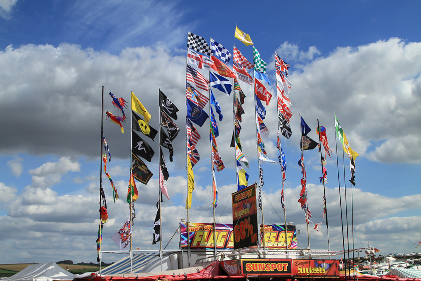 IMG 1832 
 Flags flying over the trade stands at the Great Dorset Steam Fair. 
 Keywords: Flags Flying Great Dorset Steam Fair GDSF Sky Clouds Colourful Blue Sky Banner Wind Blow